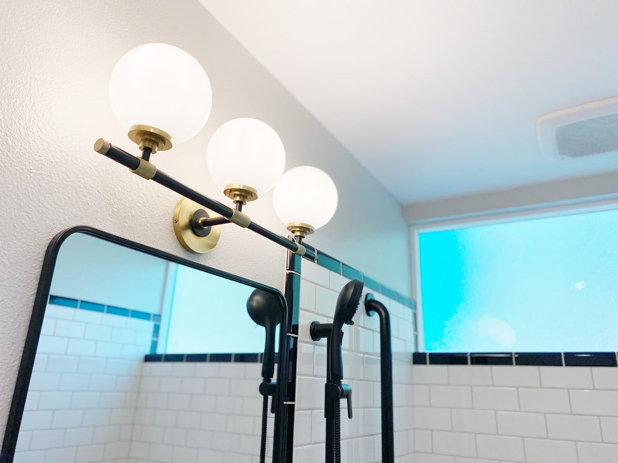Bowery Bath And Vanity 23.75" styled in a powder room for warm, layered light at Laurie Yapp Home.