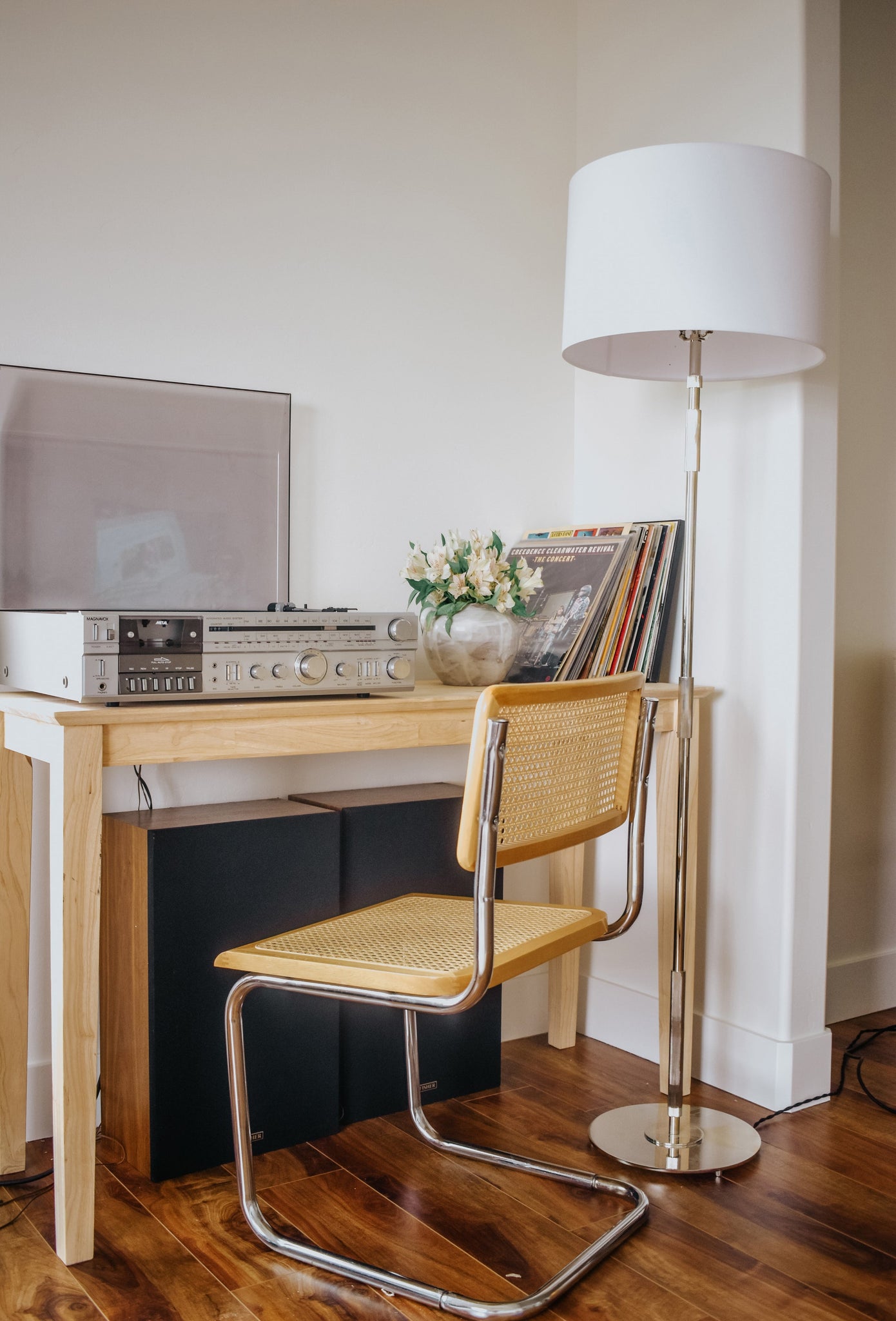 Bowery Floor Lamp in polished nickel styled in a living room corner for warm, layered light at Laurie Yapp Home.