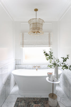 Brasher Chandelier in aged brass styled in a formal living room for warm, layered light at Laurie Yapp Home.