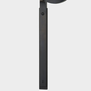 Close-up of the Brewster Wall Sconce in bronze showing the arm curve and shade silhouette.