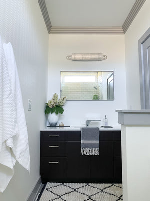 Buckley Bath And Vanity 31" in polished nickel styled in a powder room for warm, layered light at Laurie Yapp Home.