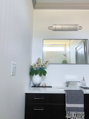 Buckley Bath And Vanity 31" in polished nickel styled in a primary ensuite for warm, layered light at Laurie Yapp Home.