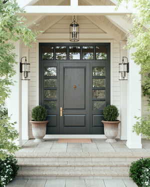 Burbank Exterior Wall Sconce 10" styled in a warmly lit hallway for warm, layered light at Laurie Yapp Home.