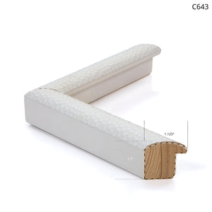White decorative frame corner with a textured surface and visible wood backing.