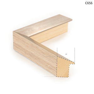 Wood and metal frame sample with a light wood finish and metallic edge.