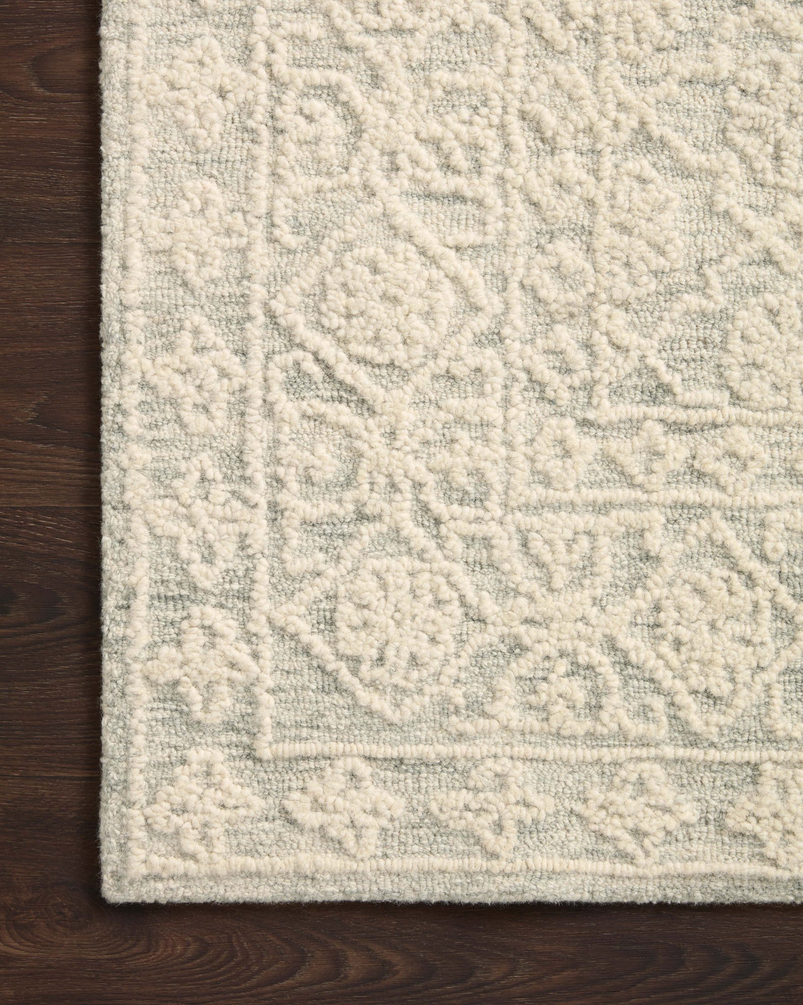 Side view of the Cecelia Mist / Ivory rug.