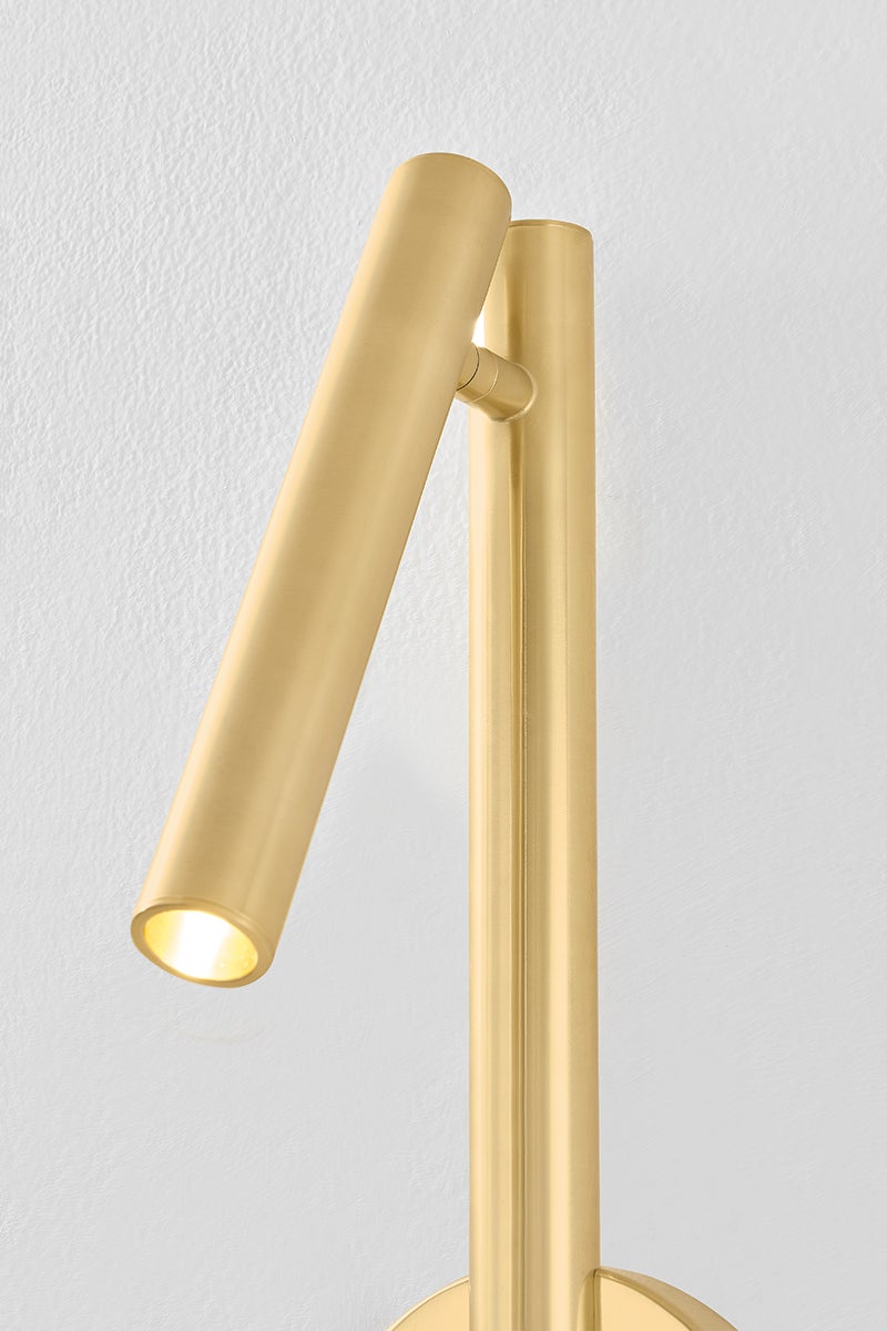Close-up of the Circleville Wall Sconce in aged brass showing the arm curve and shade silhouette.