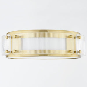 Clifford Flush Mount in aged brass shown from the front to reveal the shade profile and mounting canopy.