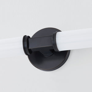 Close-up of the Cromwell Wall Sconce 4.75" x 22.75" in bronze showing the arm curve and shade silhouette.