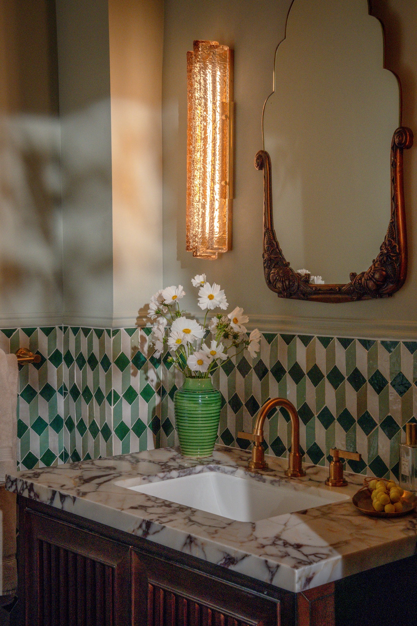 Carnelian Wall Sconce styled in a modern bathroom for warm, layered light at Laurie Yapp Home.