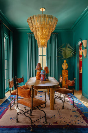 Cassian Chandelier 44.5" in aged brass styled in an elegant dining room for warm, layered light at Laurie Yapp Home.
