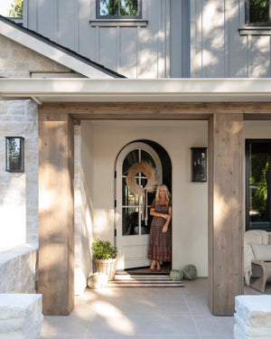 Chauncey Exterior Wall Sconce 9.5" x 19" styled in a modern bathroom for warm, layered light at Laurie Yapp Home.