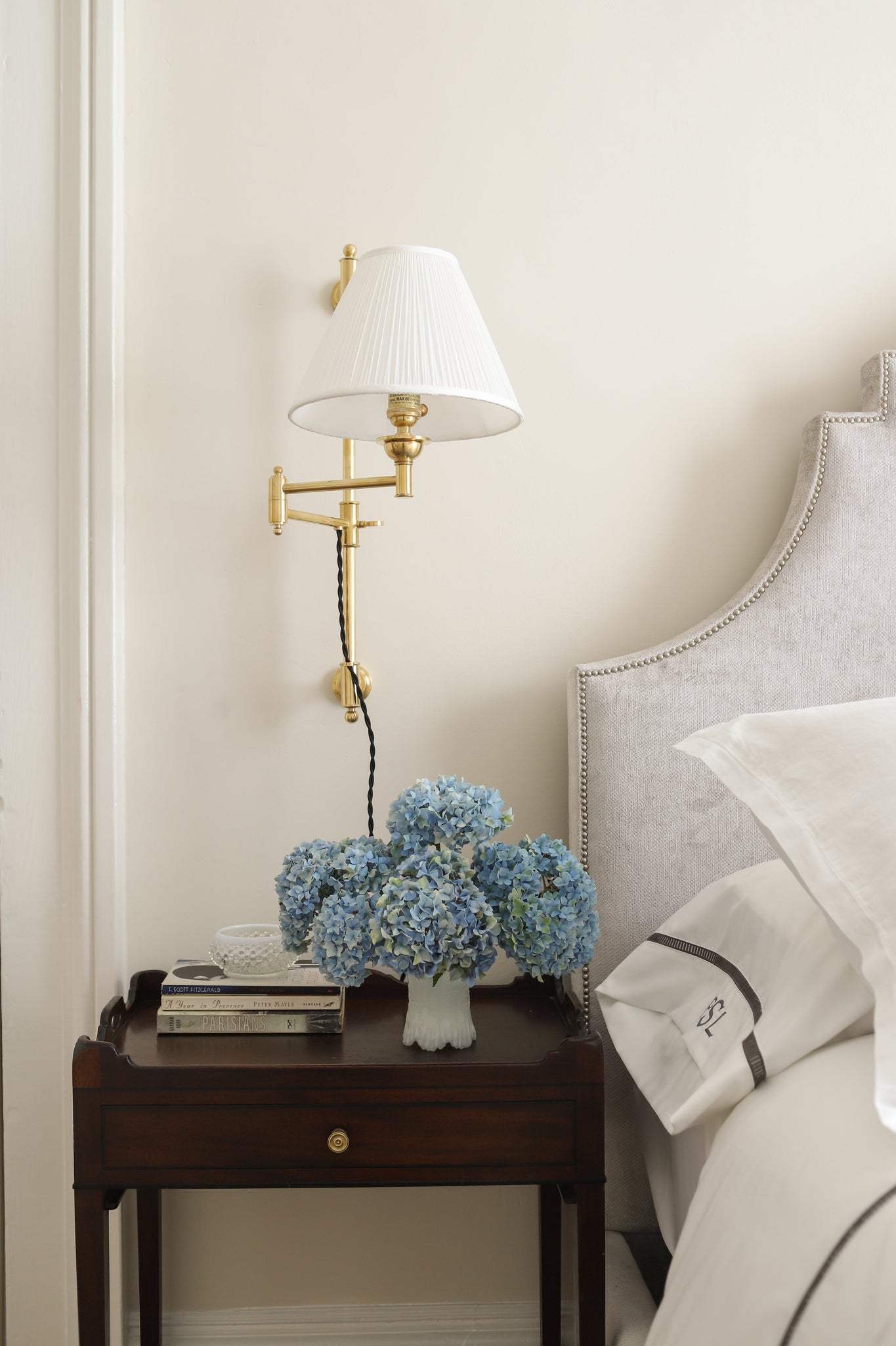 Classic No.1 Plug-In Sconce in aged brass styled in a living room for warm, layered light at Laurie Yapp Home.