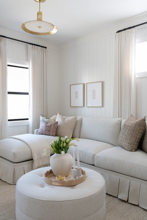 Clermont Pendant 20" in aged brass styled in a welcoming entryway for warm, layered light at Laurie Yapp Home.