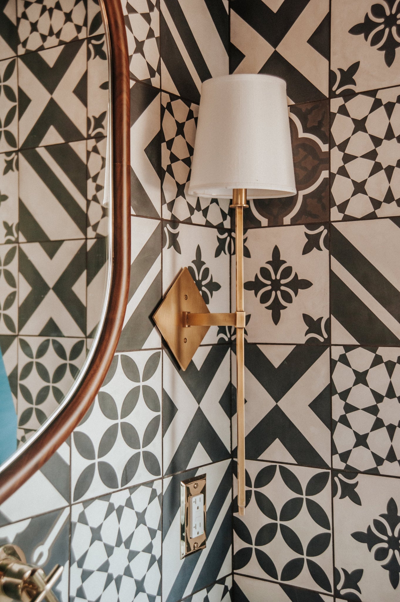 Cortland Wall Sconce in aged brass shown from the front to reveal the arm curve and shade silhouette.