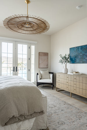 Costa Mesa Pendant 50" styled in an elegant dining room for warm, layered light at Laurie Yapp Home.