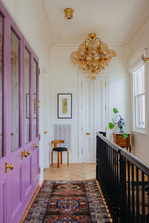 Cronus Chandelier 44.5" styled in a two-story entry for warm, layered light at Laurie Yapp Home.