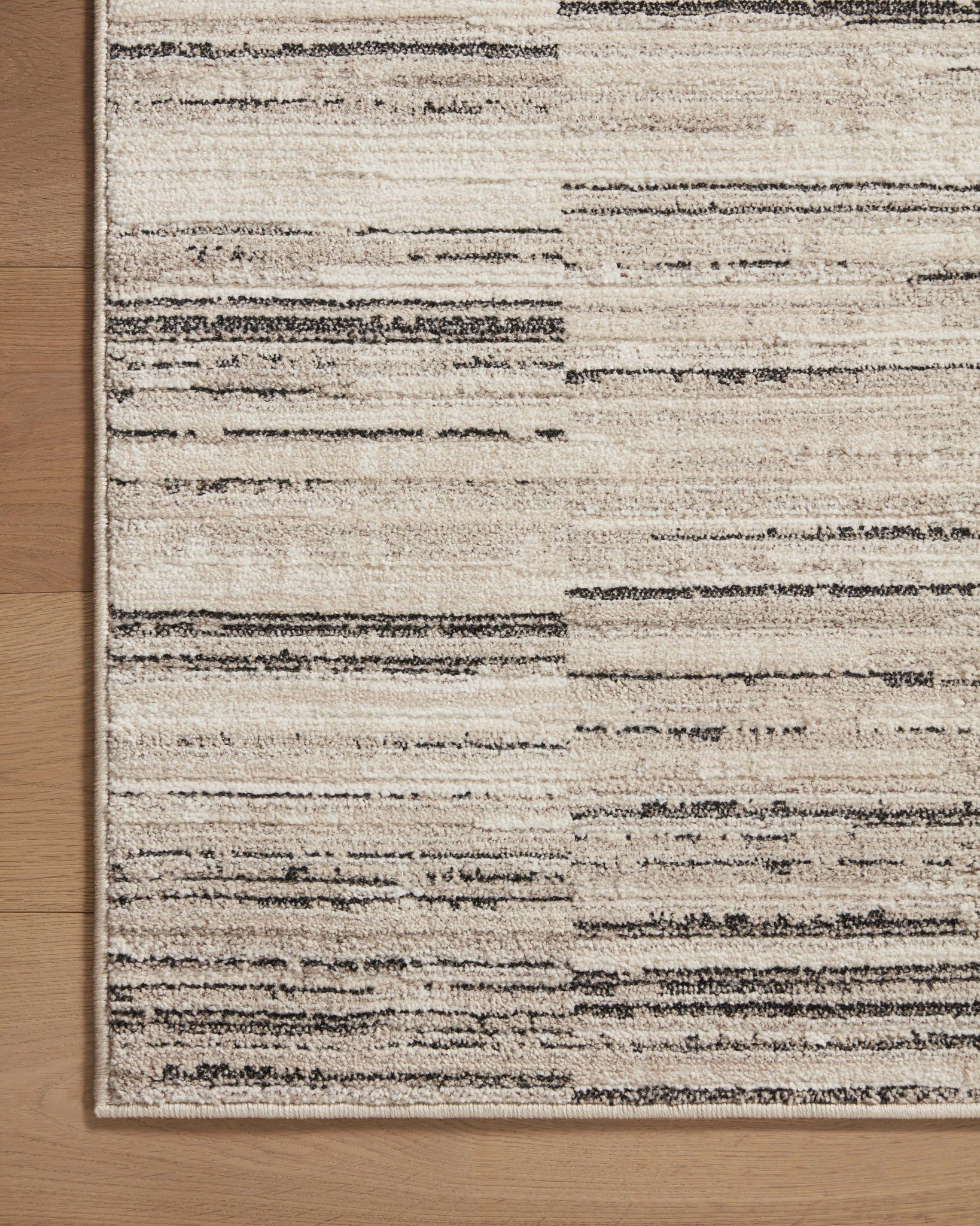 Darby Charcoal / Sand styled in a living room at Laurie Yapp Home.