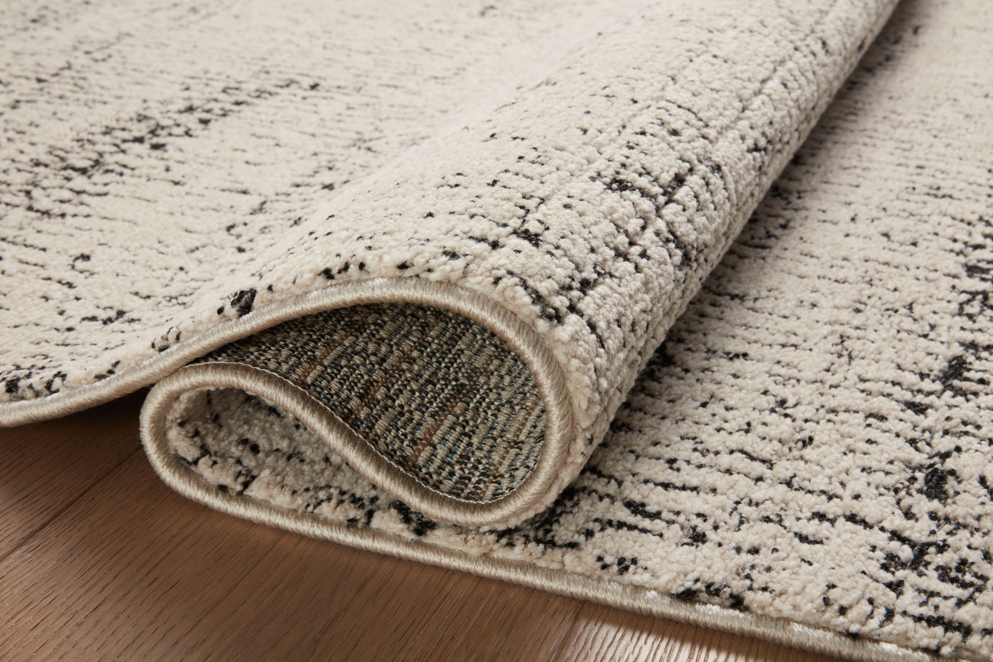 Close-up detail of the Darby Oatmeal / Charcoal showing its pile and weave.