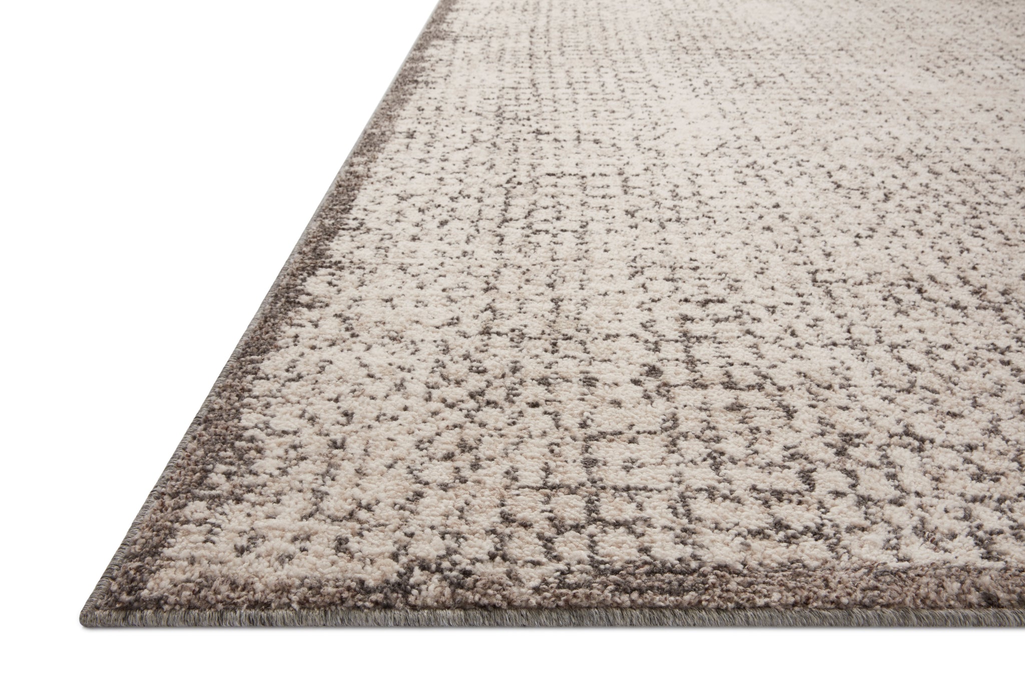 Side view of the Darby Ivory / Stone rug.