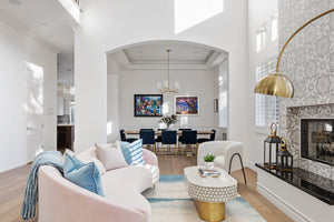 Dillon Chandelier 30" in aged brass styled in a two-story entry for warm, layered light at Laurie Yapp Home.