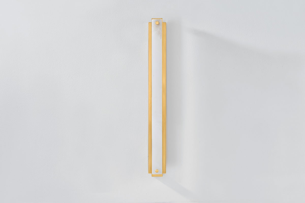 Edgemere Wall Sconce in aged brass shown from the front to reveal the arm curve and shade silhouette.