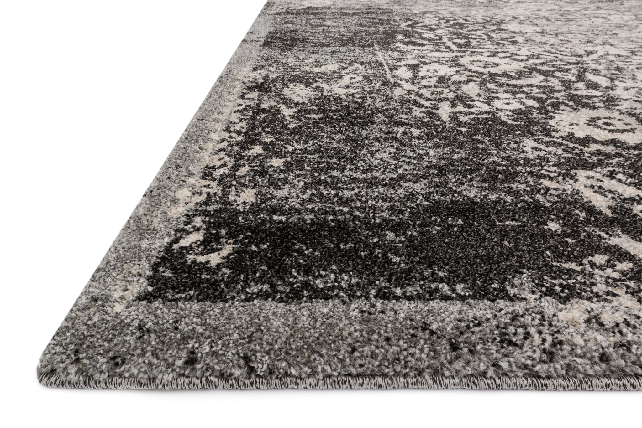 Side view of the Emory Black / Ivory rug.