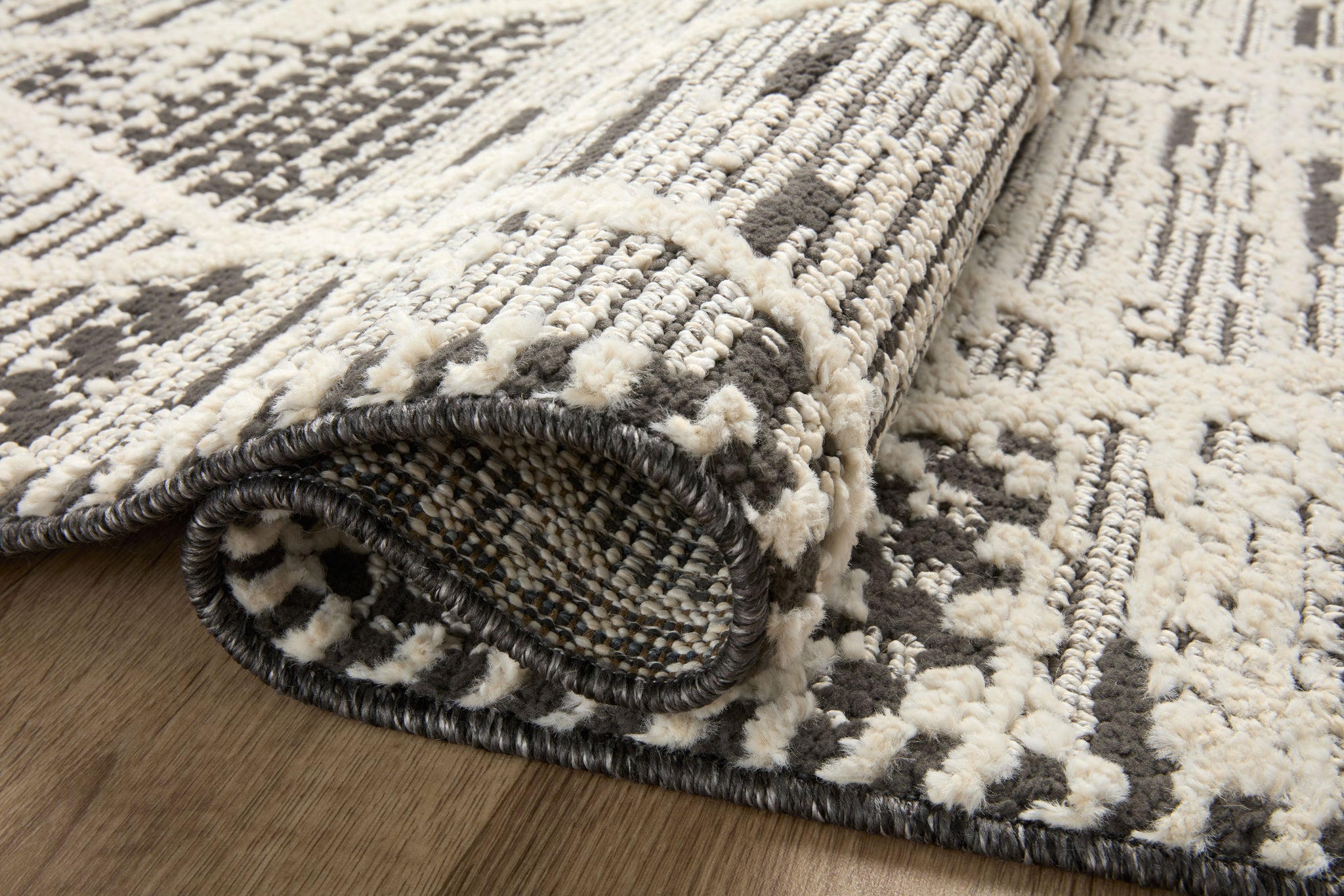 Close-up detail of the Fabian Charcoal / Ivory (Pattern 3) showing its pile and weave.