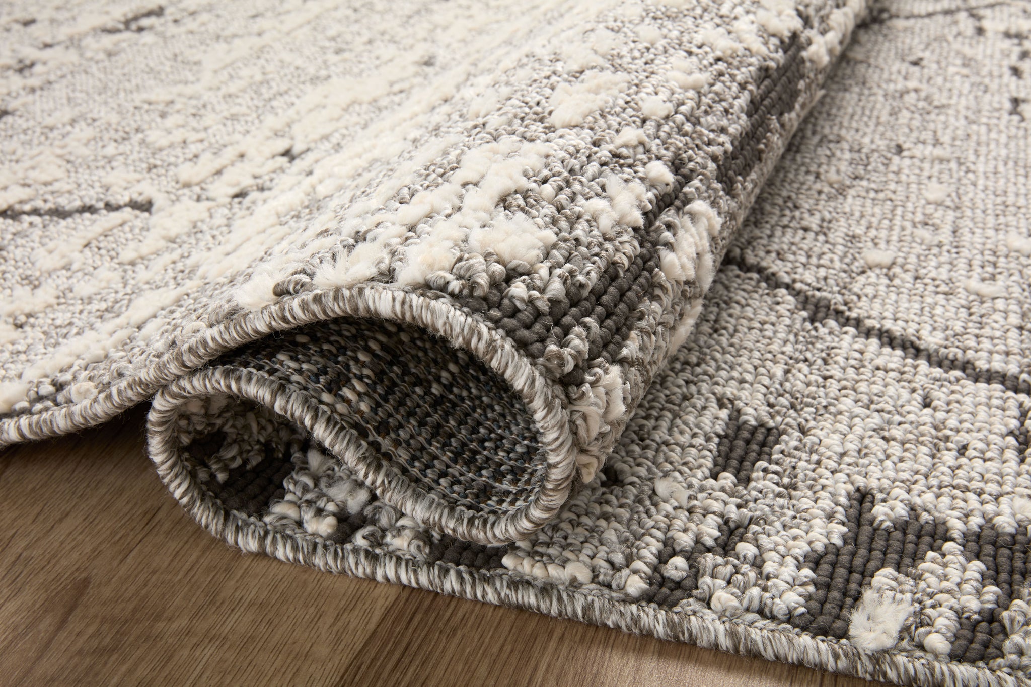 Close-up detail of the Fabian Grey / Charcoal showing its pile and weave.