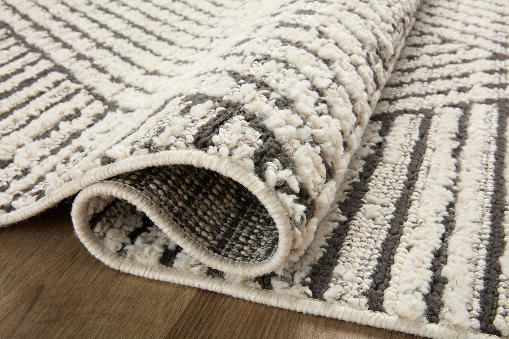 Close-up detail of the Fabian Charcoal / Ivory (Pattern 6) showing its pile and weave.