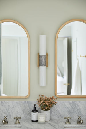 Fremont Wall Sconce styled in a modern bathroom for warm, layered light at Laurie Yapp Home.