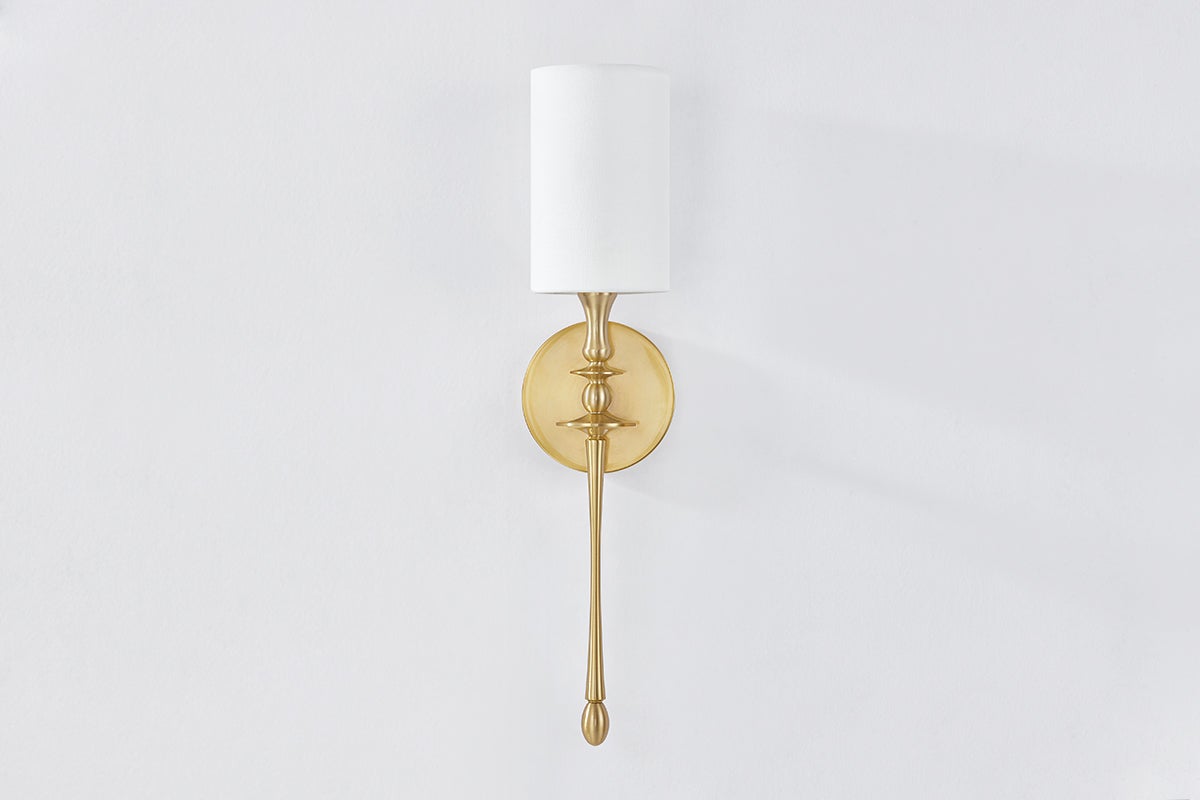 Guilford Wall Sconce in aged brass shown from the front to reveal the arm curve and shade silhouette.