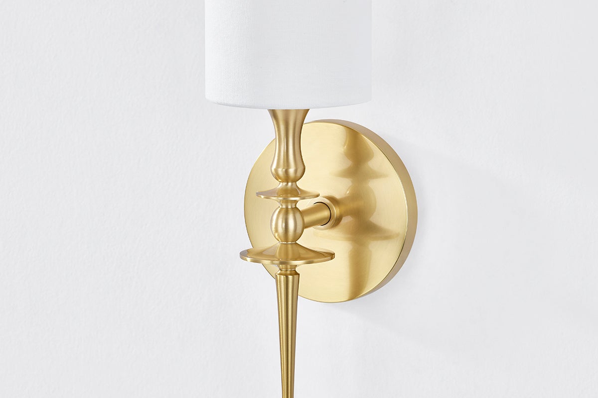 Close-up of the Guilford Wall Sconce in aged brass showing the arm curve and shade silhouette.