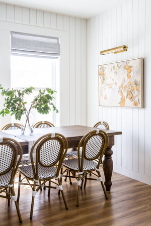 Gaines Picture Light 18.25" in aged brass styled in a gallery wall for warm, layered light at Laurie Yapp Home.