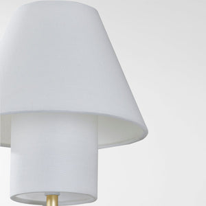 Close-up of the Glenmoore Wall Sconce in aged brass showing the arm curve and shade silhouette.