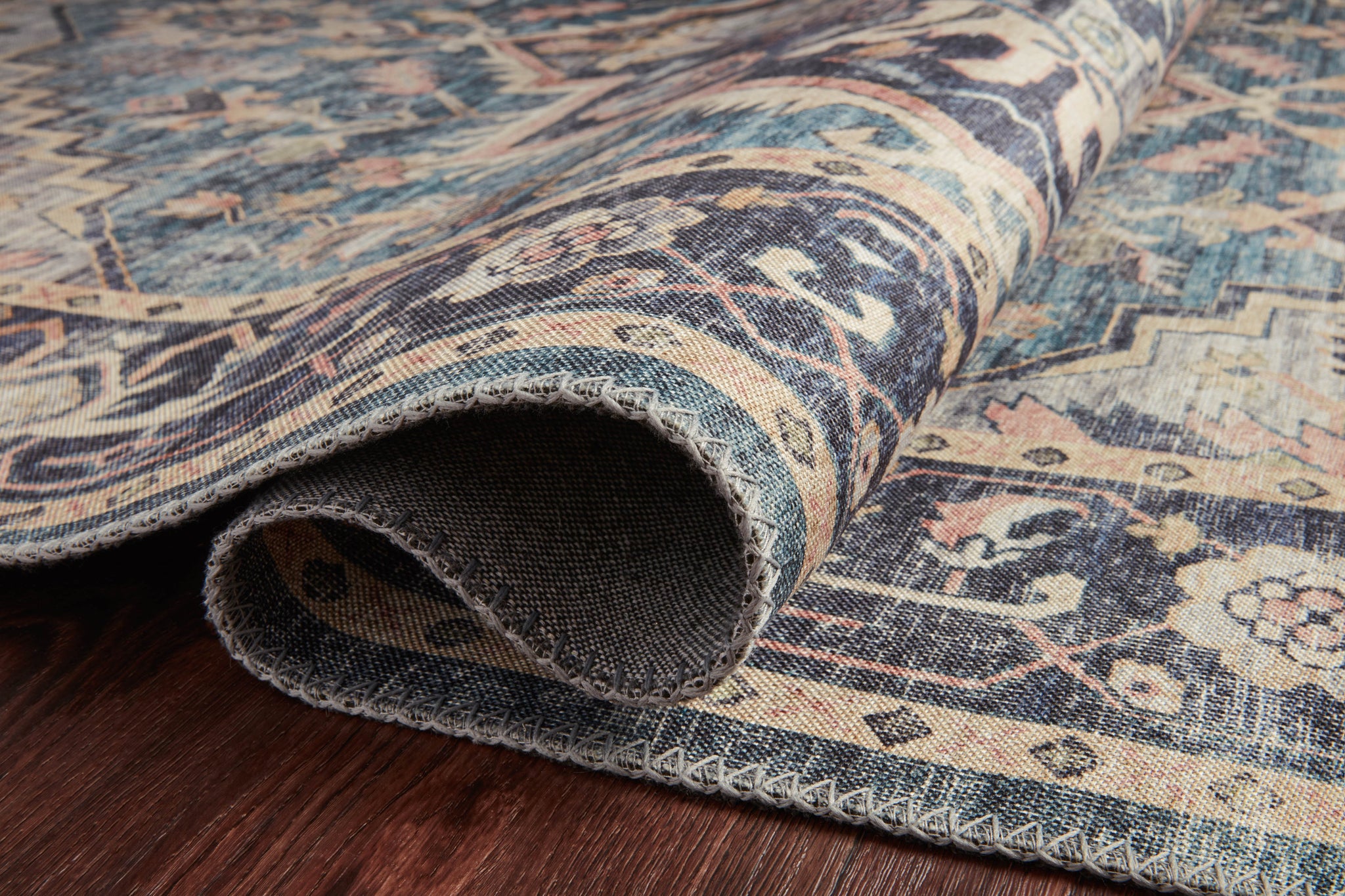 Hathaway Navy / Multi styled underfoot in a layered living room at Laurie Yapp Home.