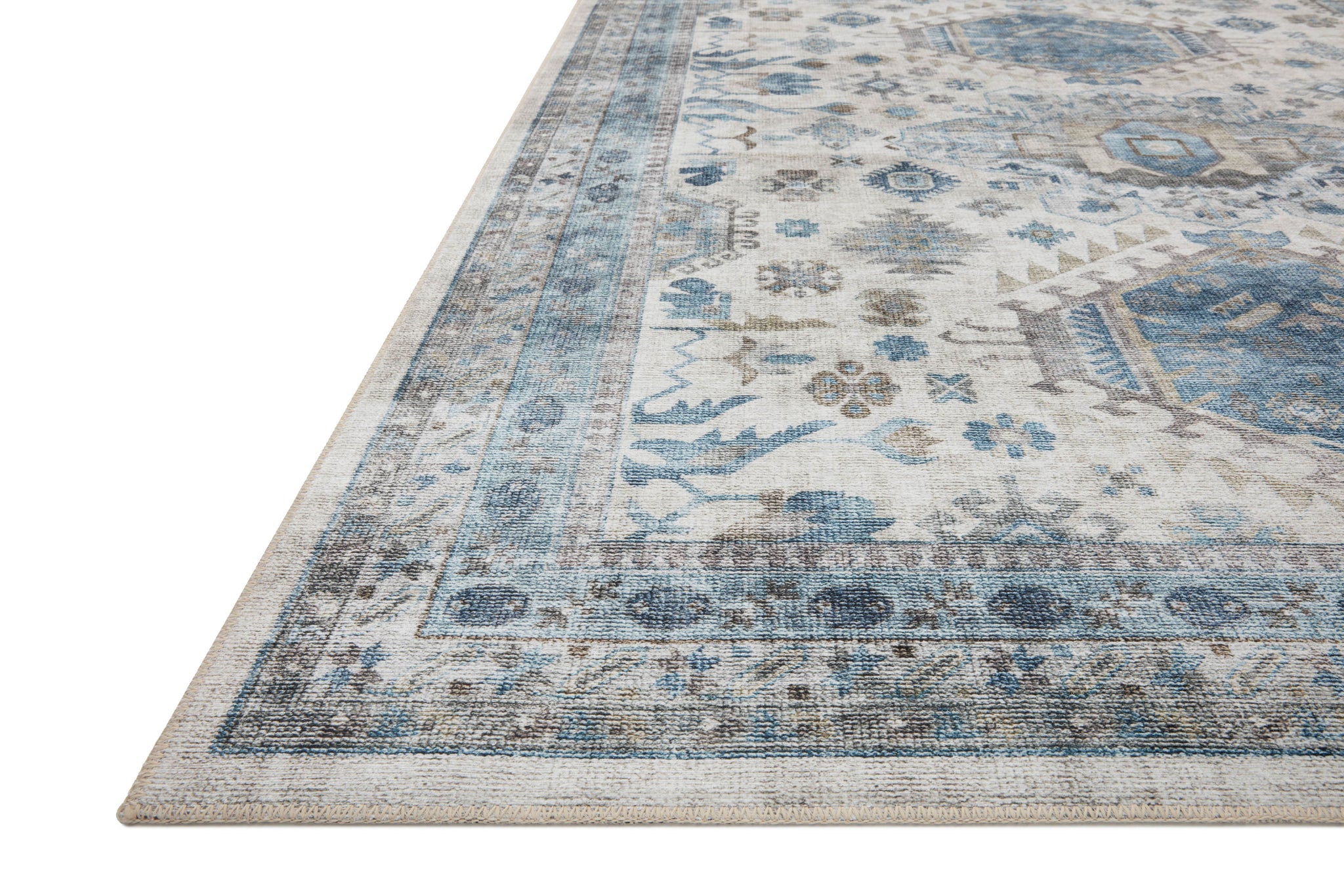 Side view of the Heidi Ivory / Ocean rug.