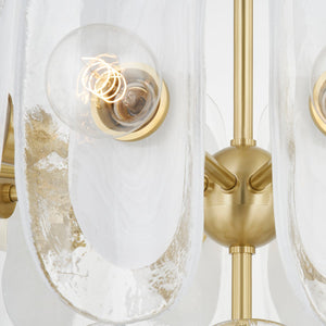 Hilo Chandelier in aged brass shown from the front to reveal the frame, arms, and shade detail.