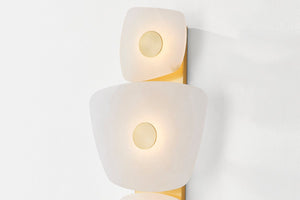 Close-up of the Holmdel Wall Sconce in aged brass showing the arm curve and shade silhouette.