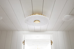 Highland Falls Flush Mount in aged brass styled in a bedroom for warm, layered light at Laurie Yapp Home.