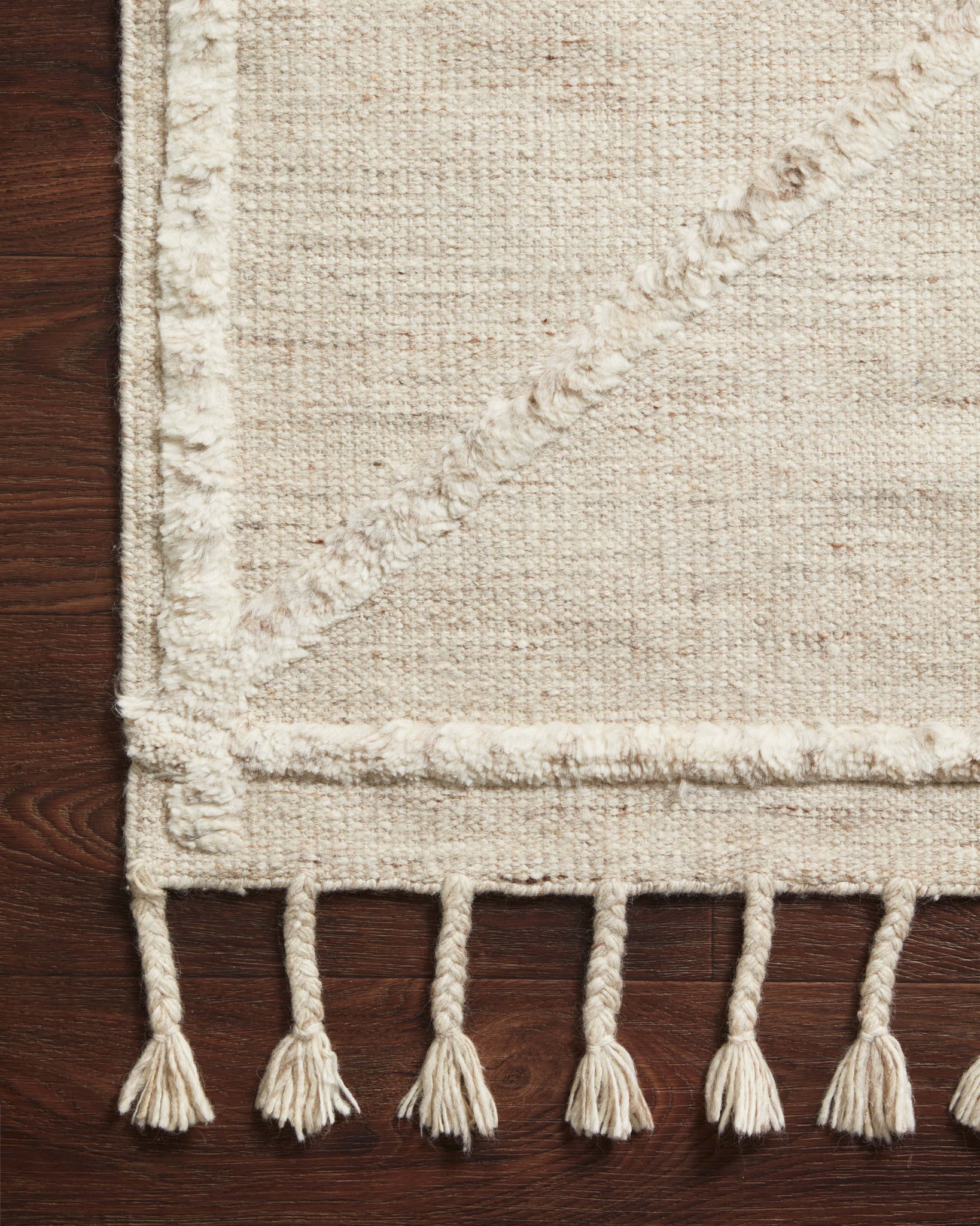 Side view of the Iman Beige / Ivory rug.