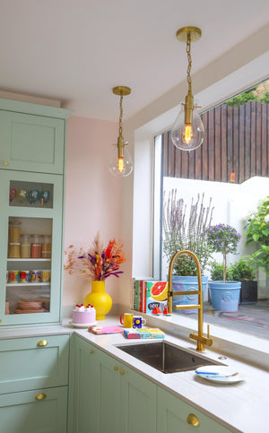 Ivy Pendant 7.5" in aged brass styled in an elegant dining room for warm, layered light at Laurie Yapp Home.