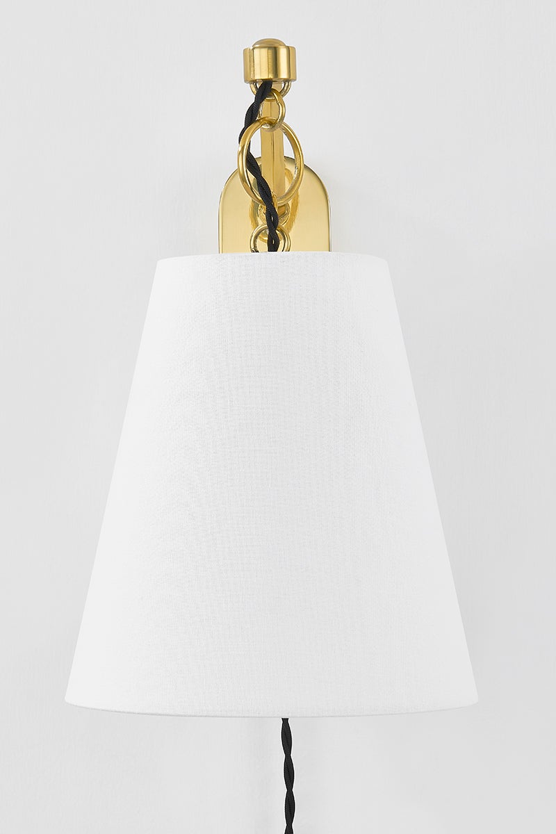 Joan Plug-In Sconce in aged brass shown from a second angle to highlight the arm profile and shade silhouette.