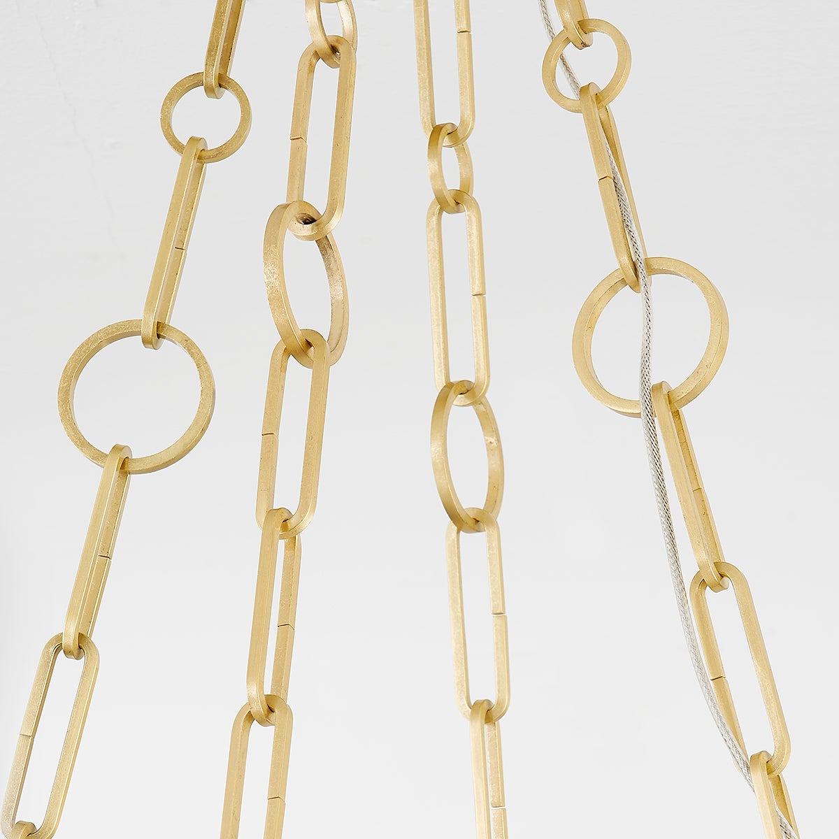 Close-up of the Kirby Chandelier 20" x 3.5" in aged brass showing the frame, arms, and shade detail.
