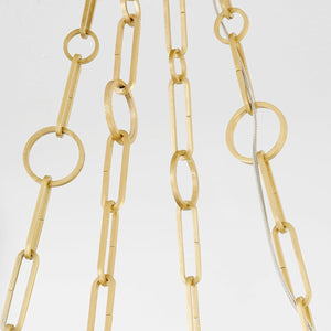 Close-up of the Kirby Chandelier 20" x 3.5" in aged brass showing the frame, arms, and shade detail.