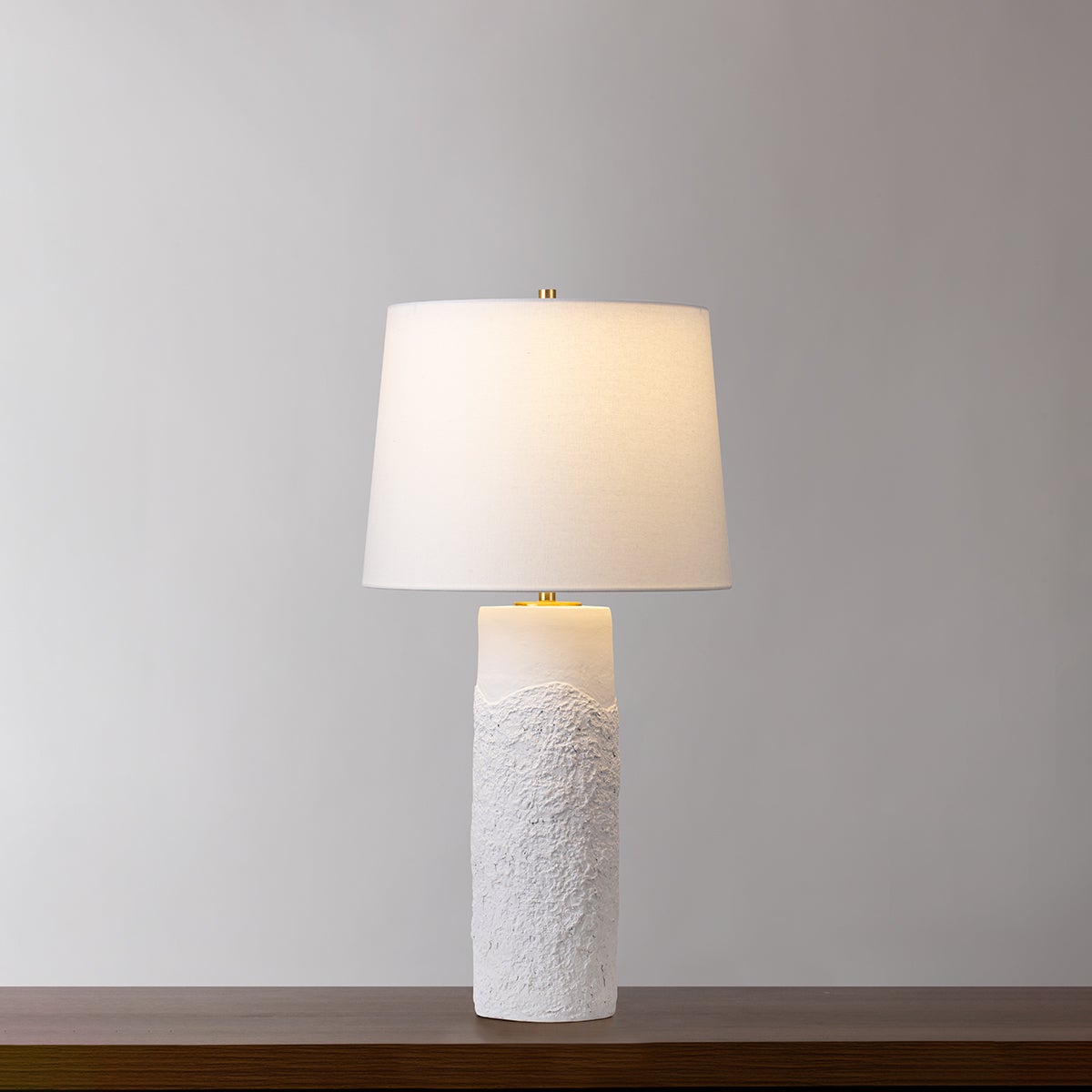Tolland Table Lamp in aged brass shown from the front to reveal the base and shade proportions.
