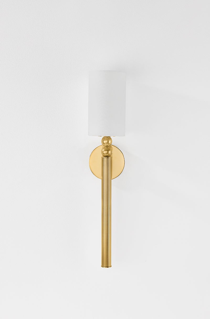 Lakeport Wall Sconce in aged brass shown from the front to reveal the arm curve and shade silhouette.