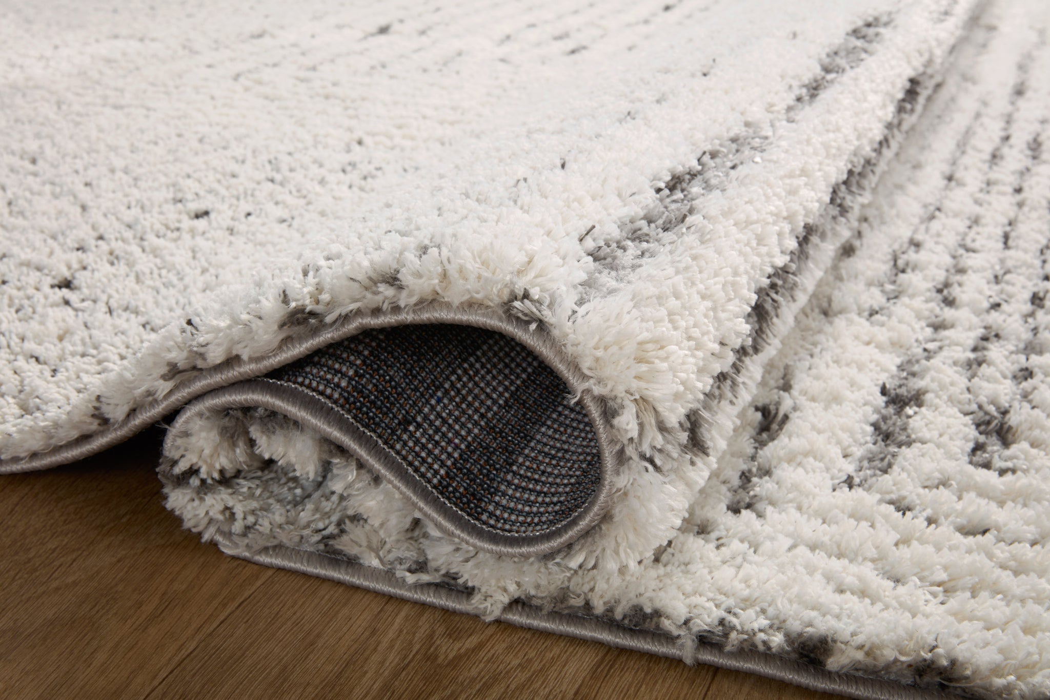 Levitt Shag Ivory / Grey shown from a different angle to reveal its pattern.