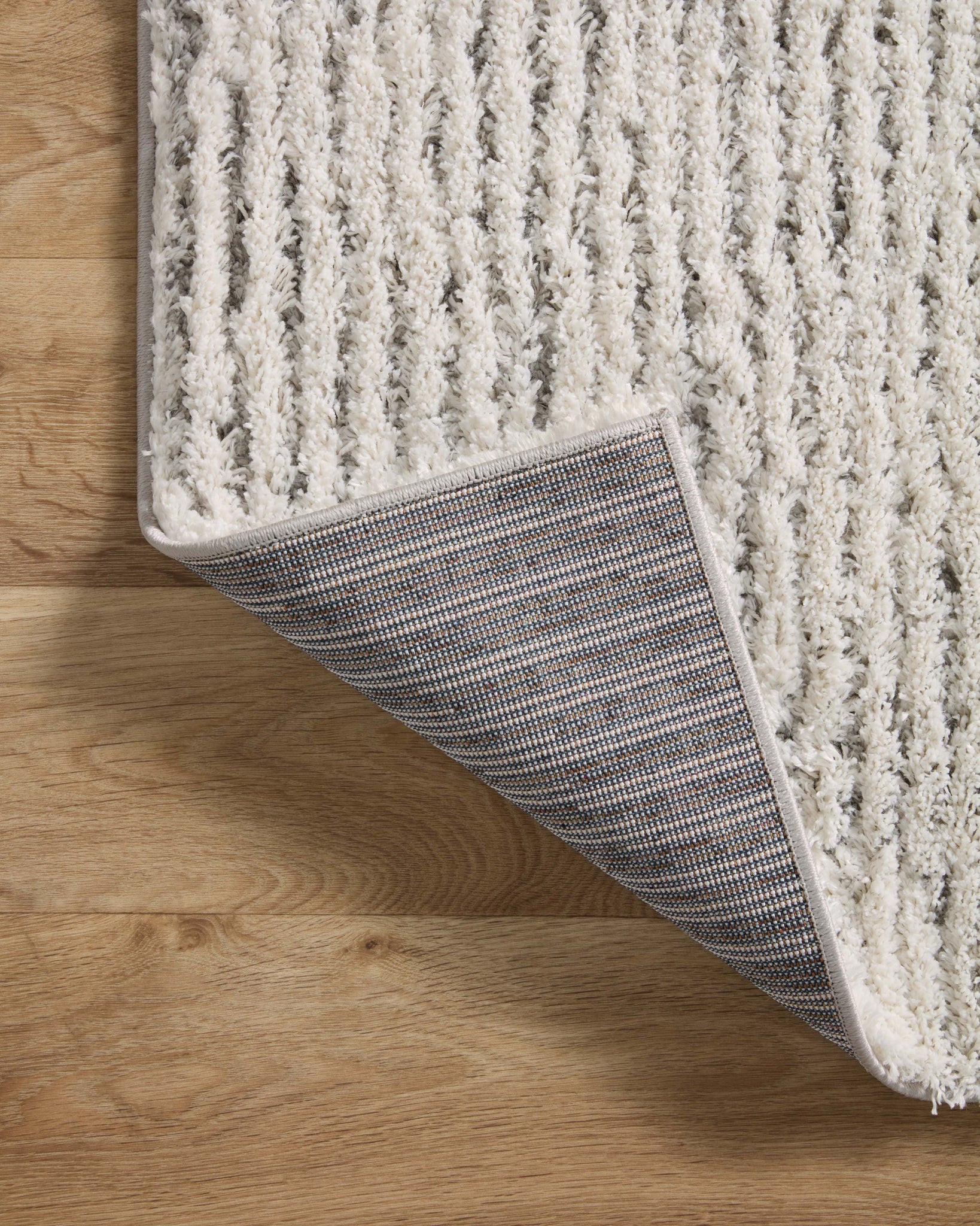 Levitt Shag Ivory / Grey shown from a different angle to reveal its pattern.