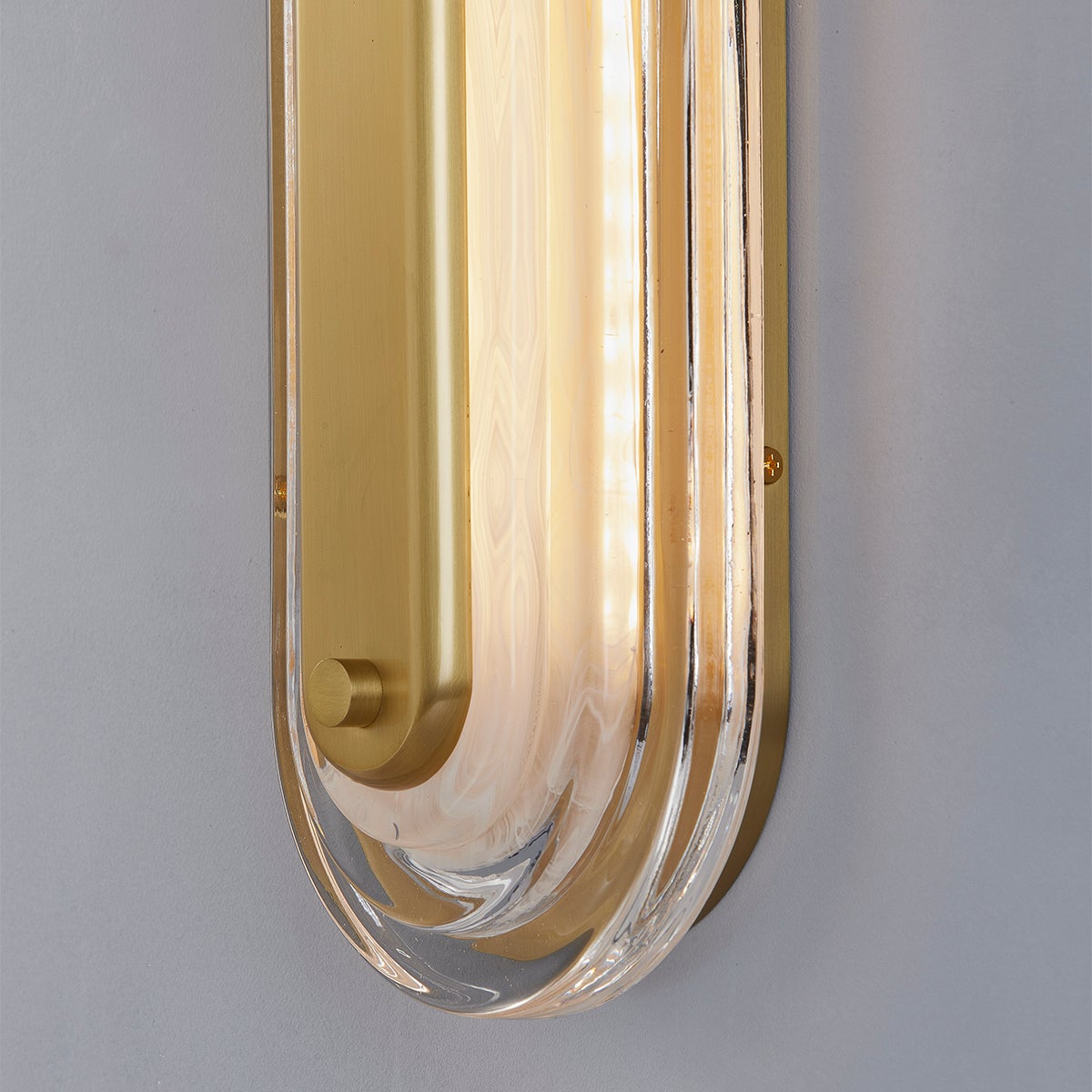 Close-up of the Litton Wall Sconce 5.75" x 28" in aged brass showing the arm curve and shade silhouette.